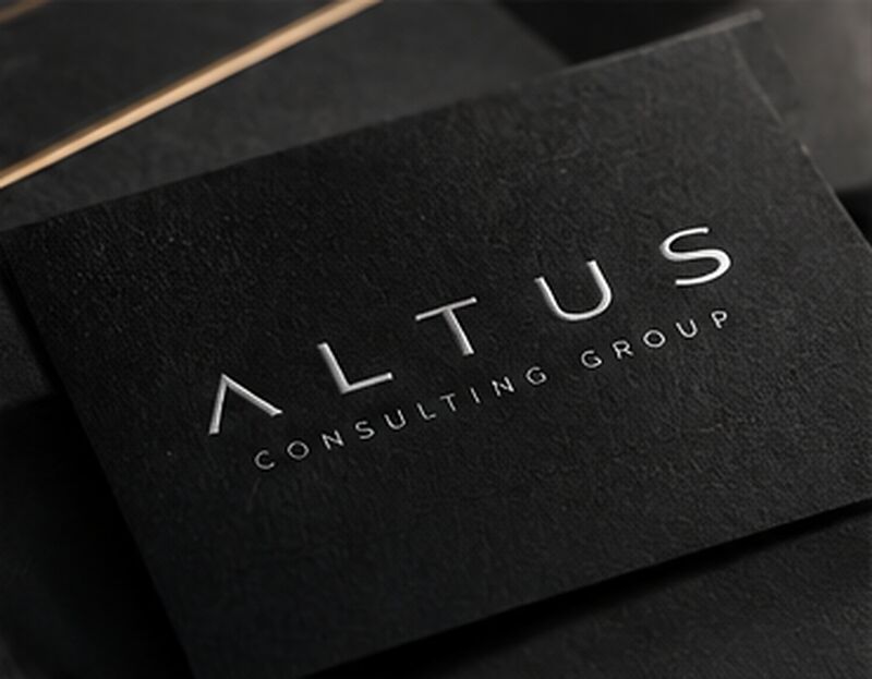 Altus Consulting Group business card on a dark surface